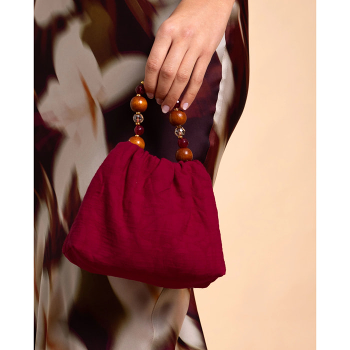 Bolso de mano con asa de piedras