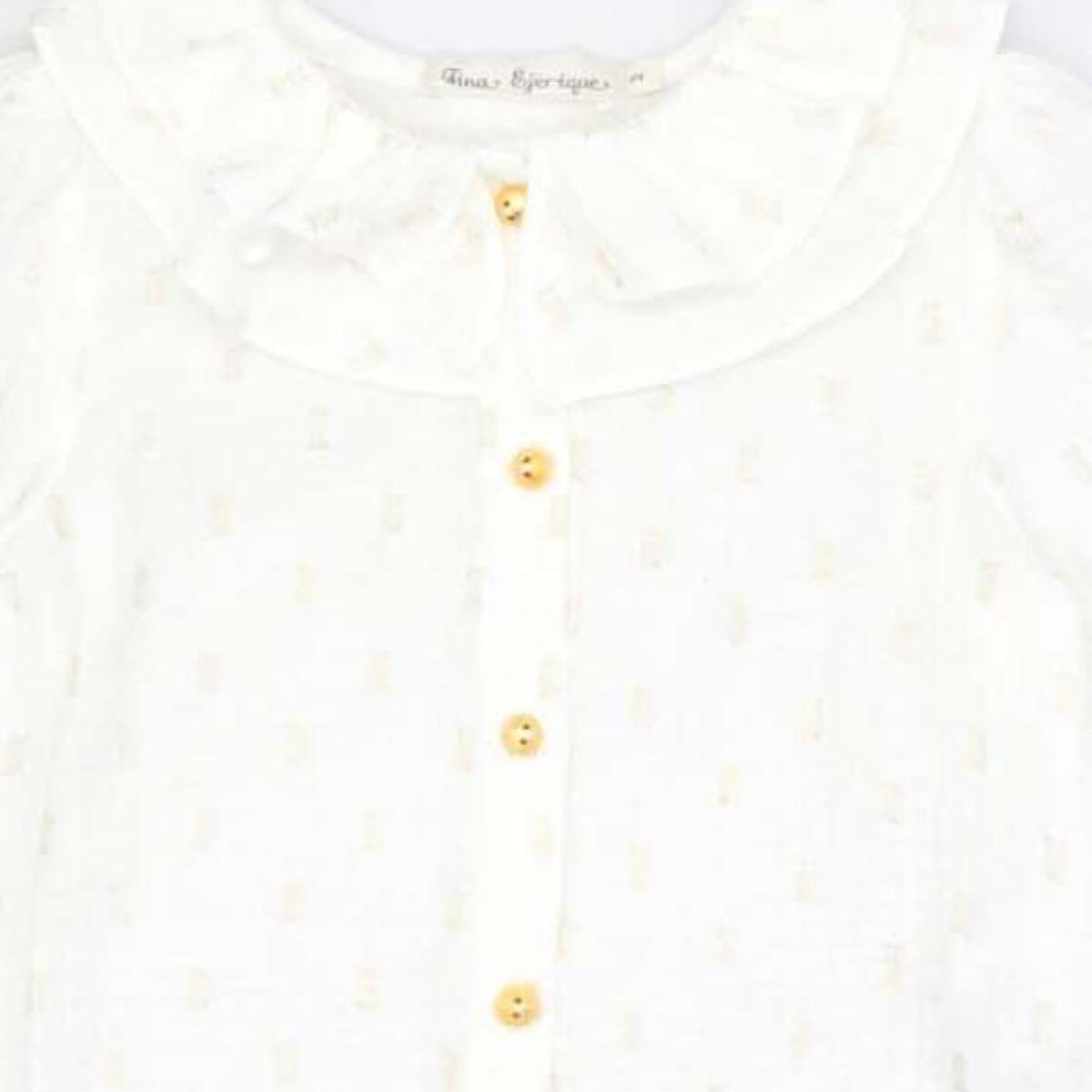 Blusa con doble cuello y manga con volumen en dorado y blanco