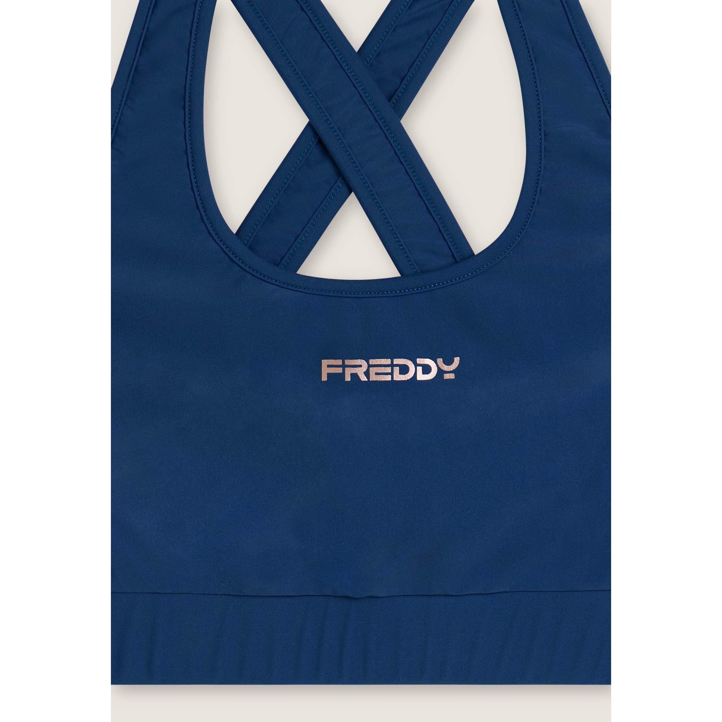 Top tecnico con spalline incrociate e profili bianchi