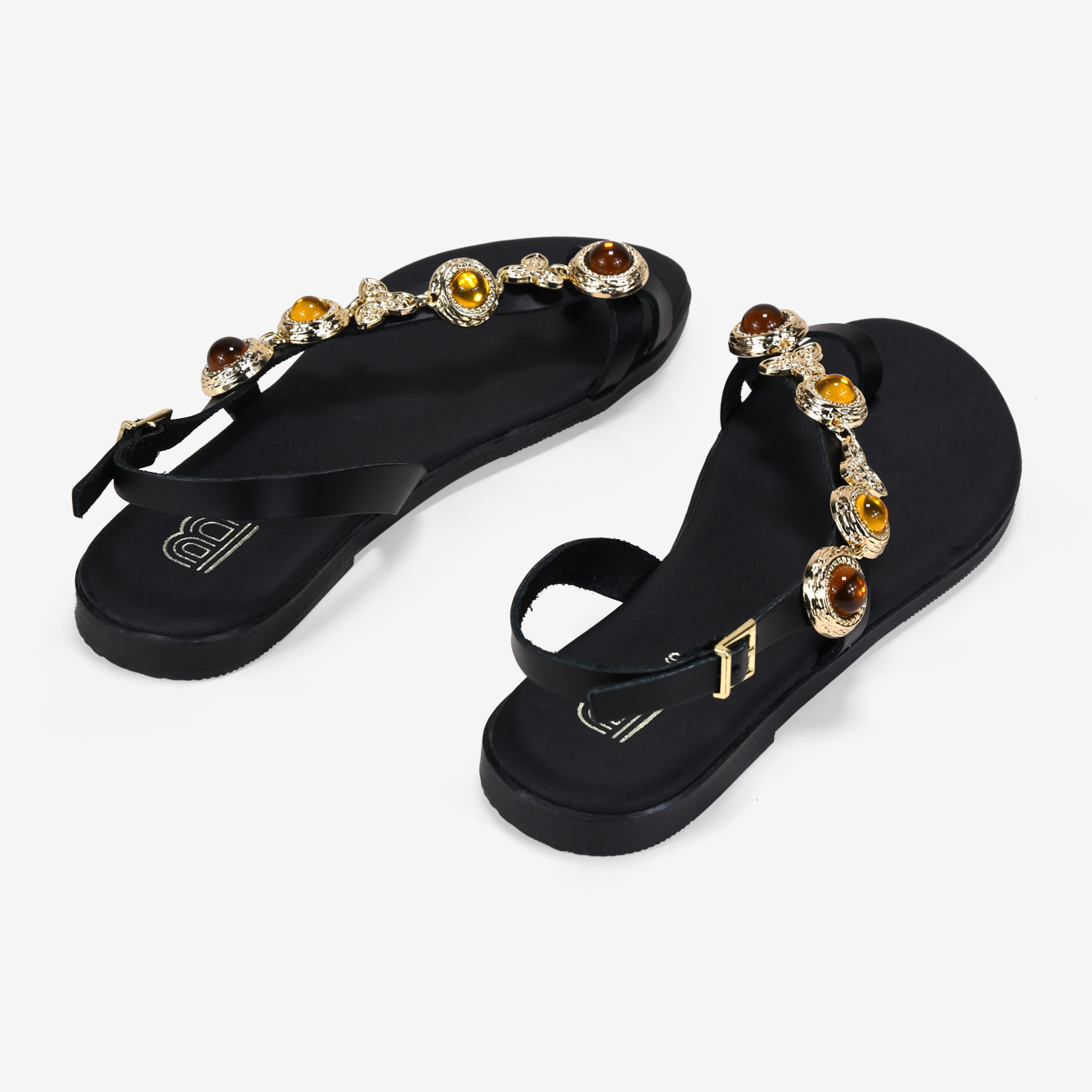 Sandalias planas negras en piel con tira joya