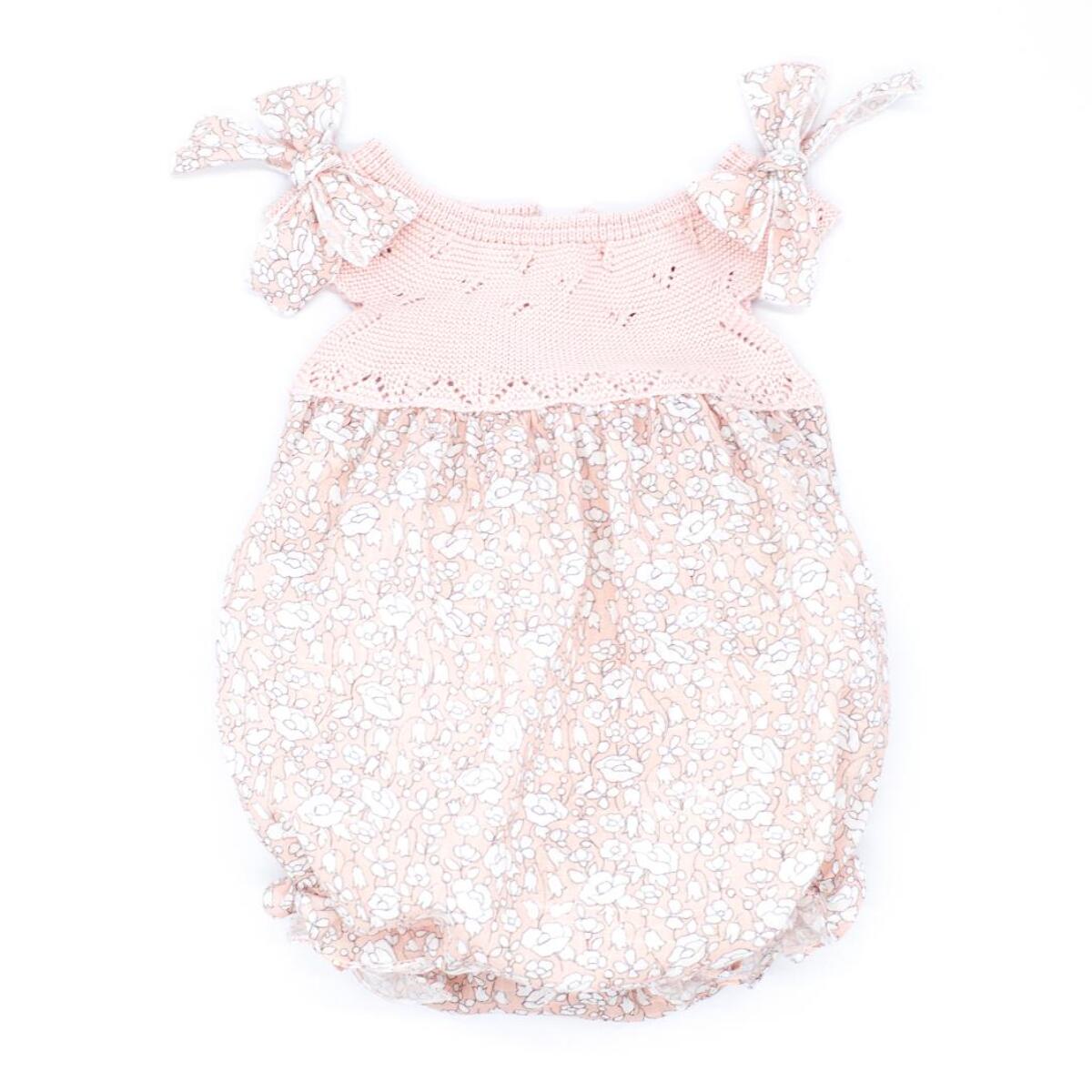 Pelele estampado de flores rosas y cuerpo de punto, lazos en el hombro.