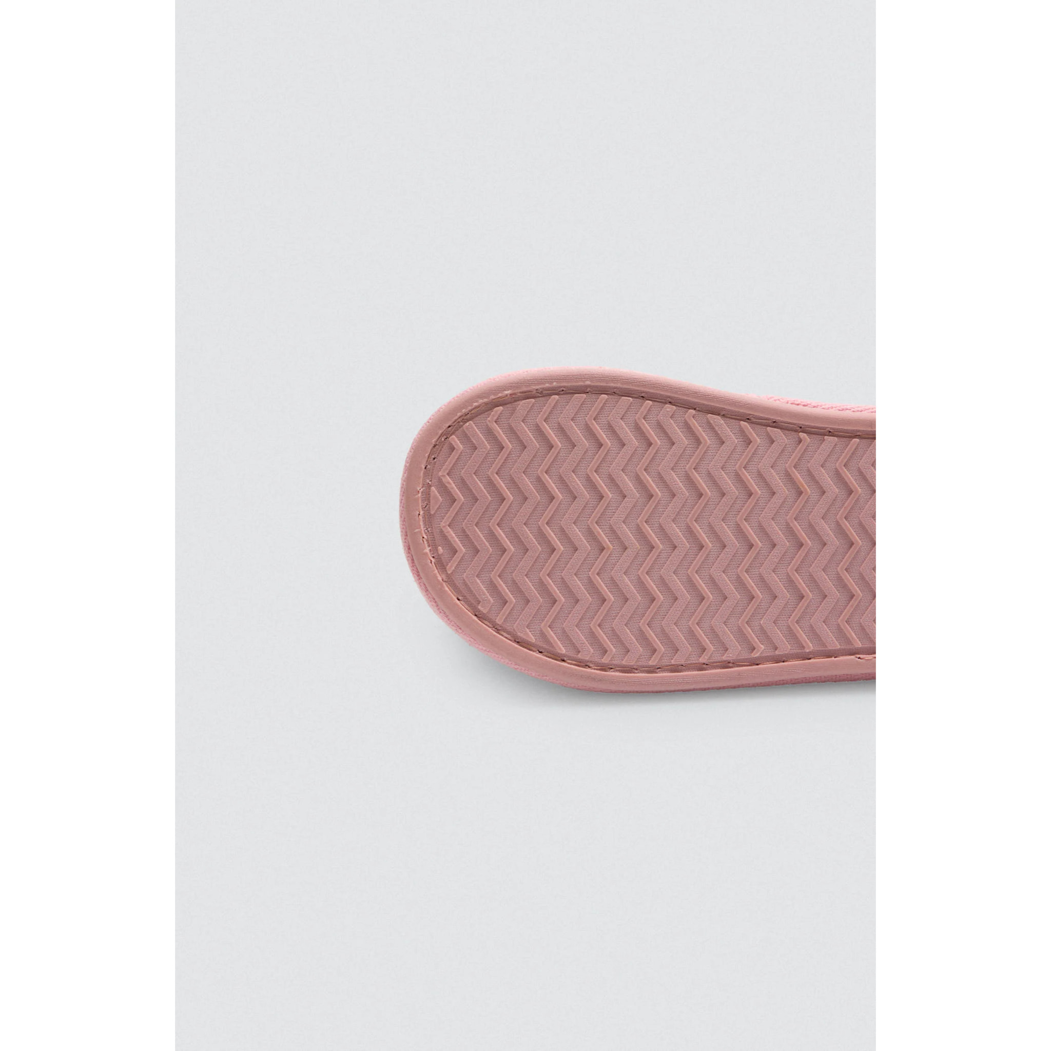 Pantofole colorate con pompon e tessuto intrecciato