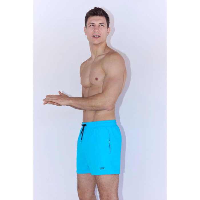 Costume corto azzurro con dettaglio tasche