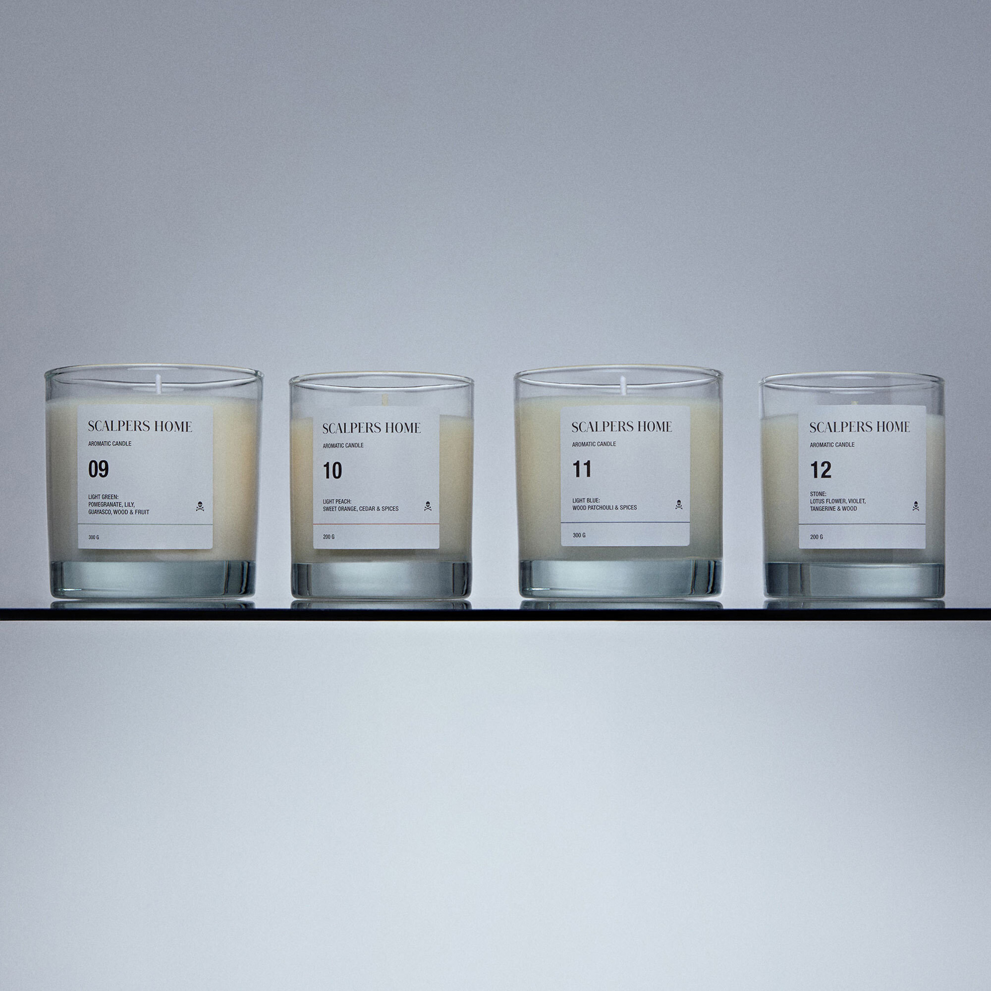 Set de 4 velas aromáticas de 200gr con aromas de light green, white lotus, light peach y stone scalpers