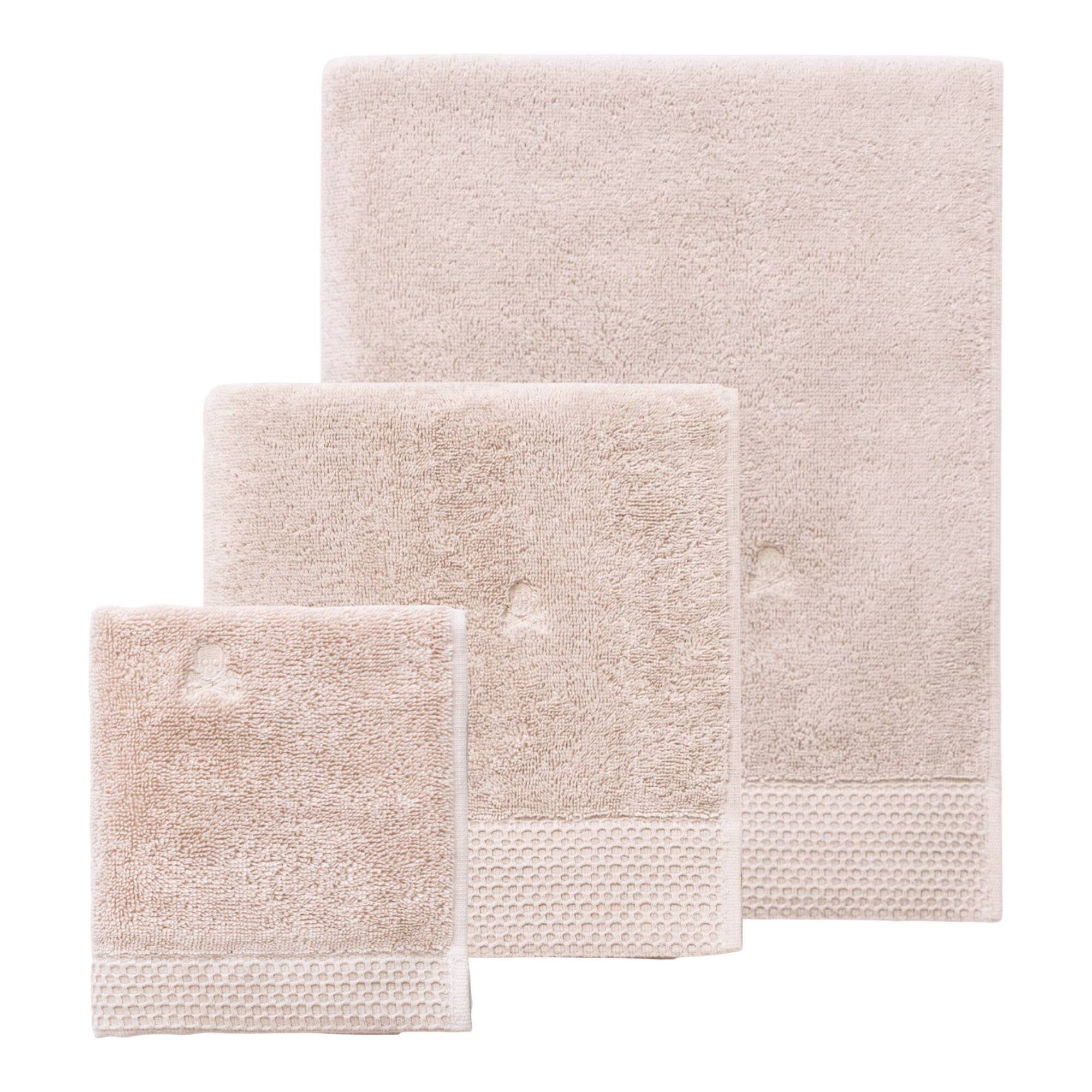 Juego de toallas nidus (30x50cm + 50x100cm + 90x150cm) 100% algodón en color crema con logo bordado scalpers home