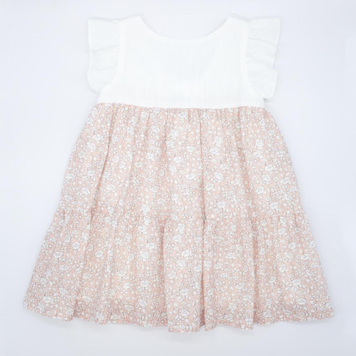 Vestido con el cuerpo en blanco y falda estampada de flores albaricoque. Con volantes en las sisas, falda fruncida de volantes.