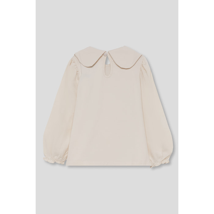 Blusa niña crudo con cuello redondo tipo bebé, jaretas delanteras, puños elásticos y cierre trasero | Color: Crudo | Street Monkey