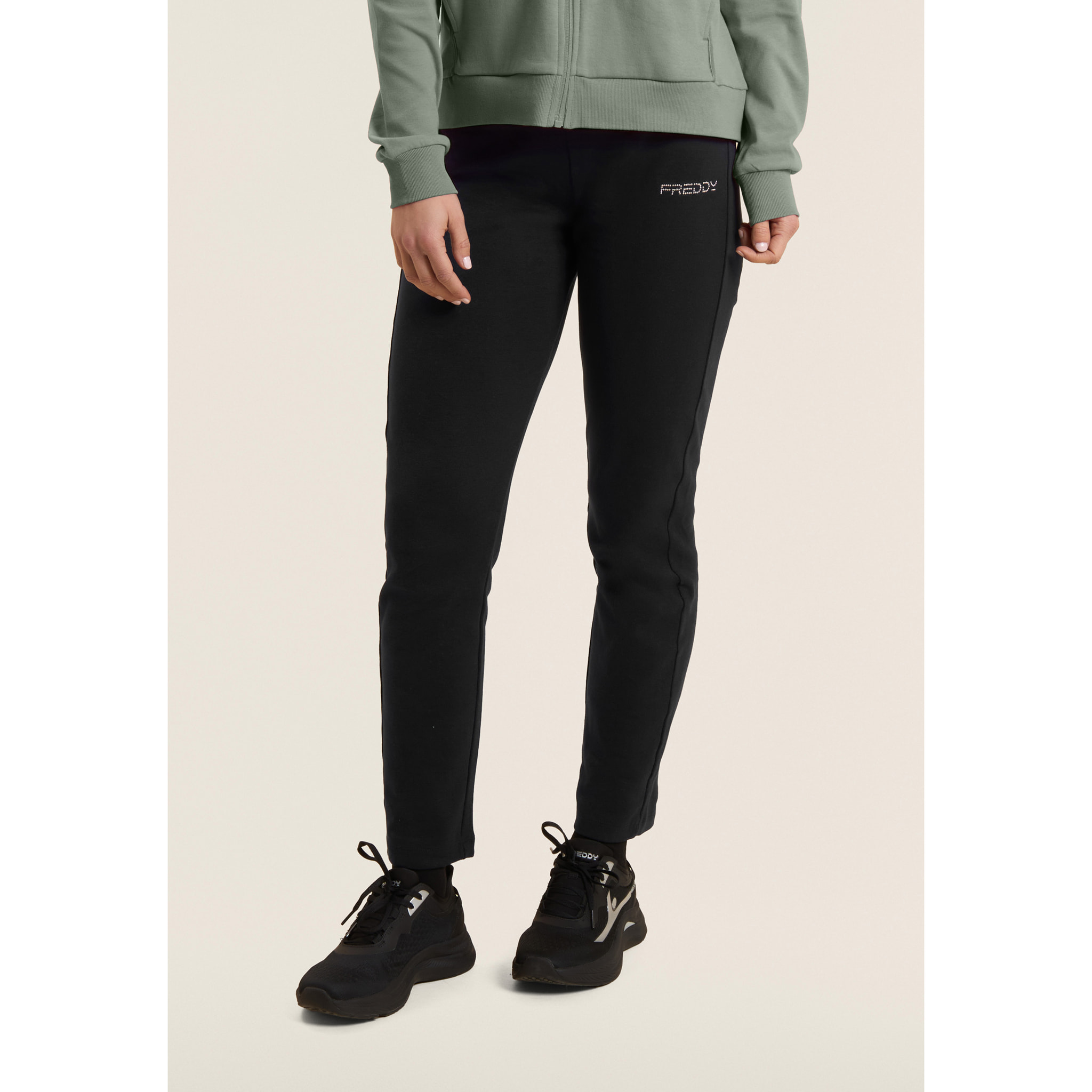 Tuta con zip e collo alto, logo in perline