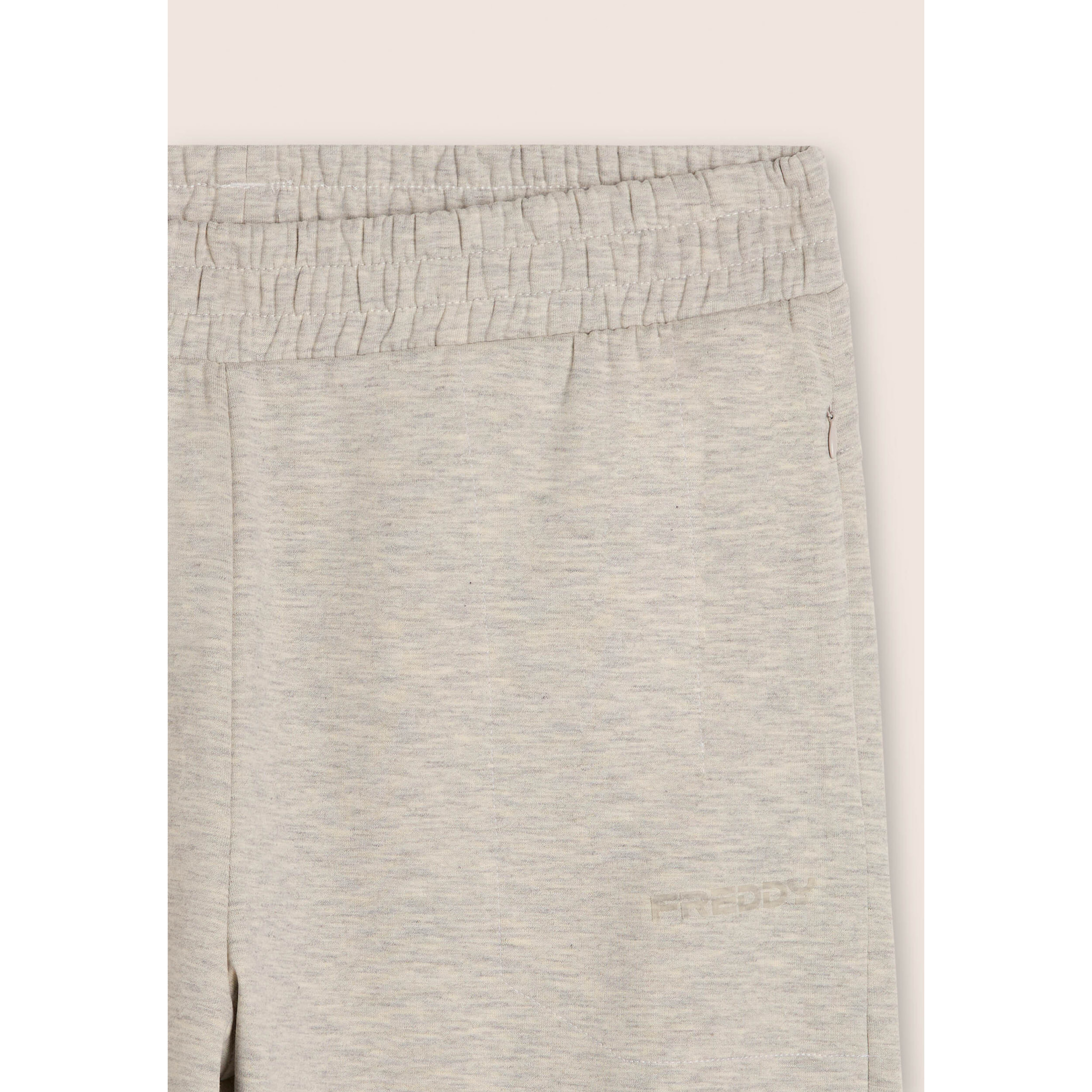 Pantaloni slim mélange con stampa trasparente e zip