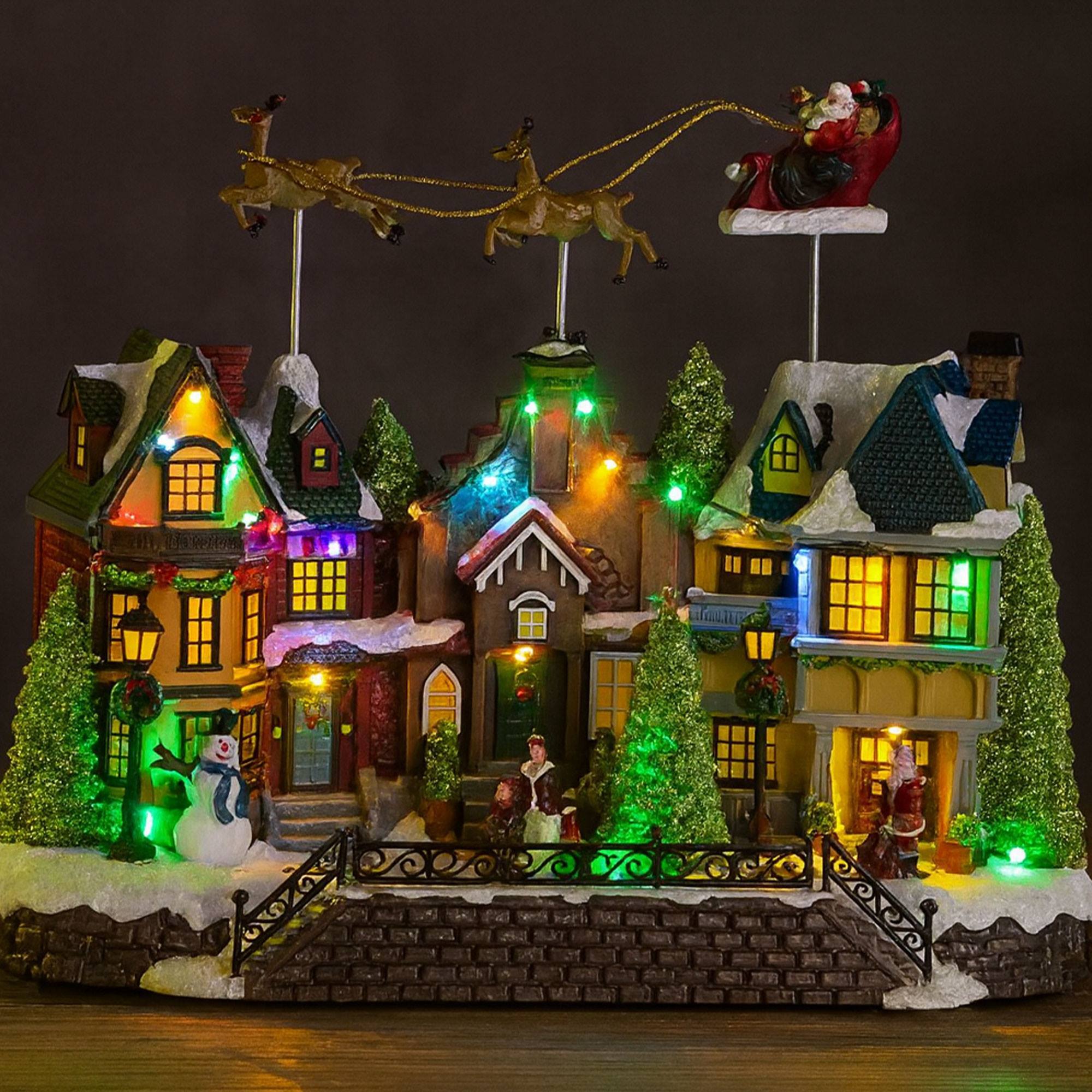 Casa navideña village con 24 luces led multicolor con sonido