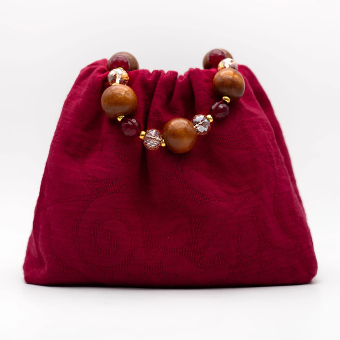 Bolso de mano con asa de piedras