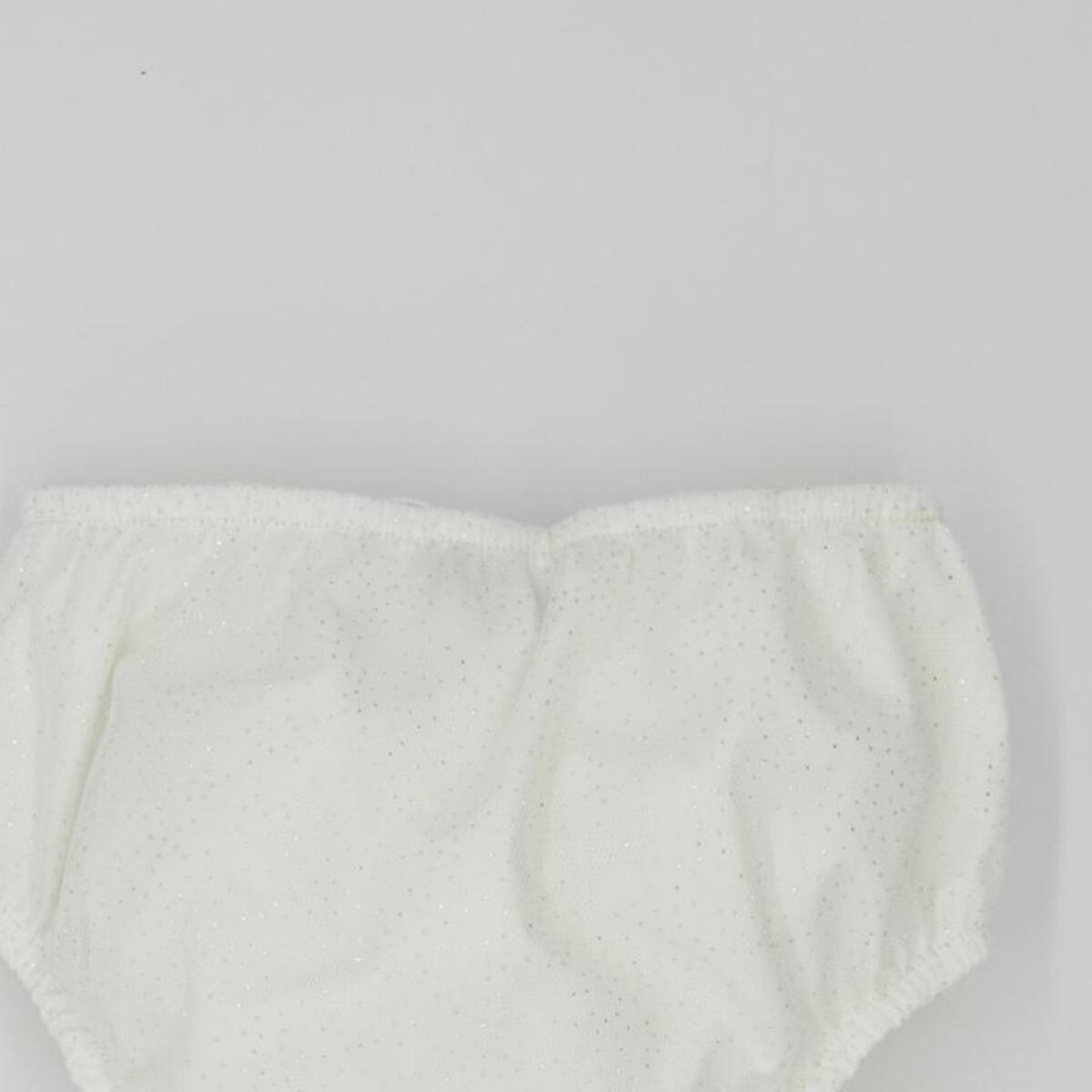 Cubrepañal de tul de chispitas. Elastico en la cintura y en las piernas.