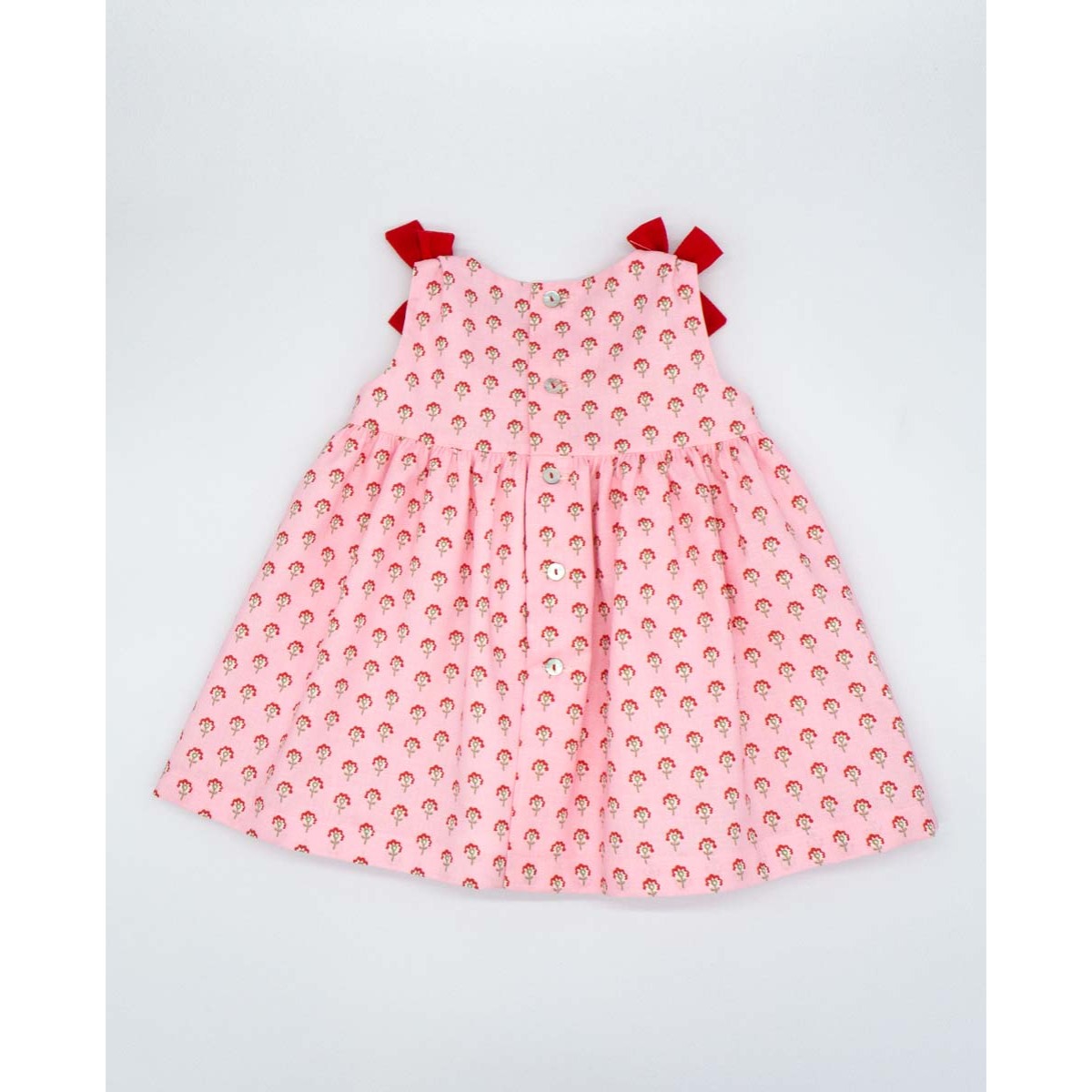 VESTIDO ROSA CON FLORES ROJAS Y LAZOS ROJOS