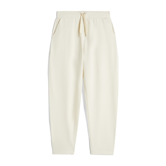 Pantaloni carrot fit in french terry con grafica sul fondo