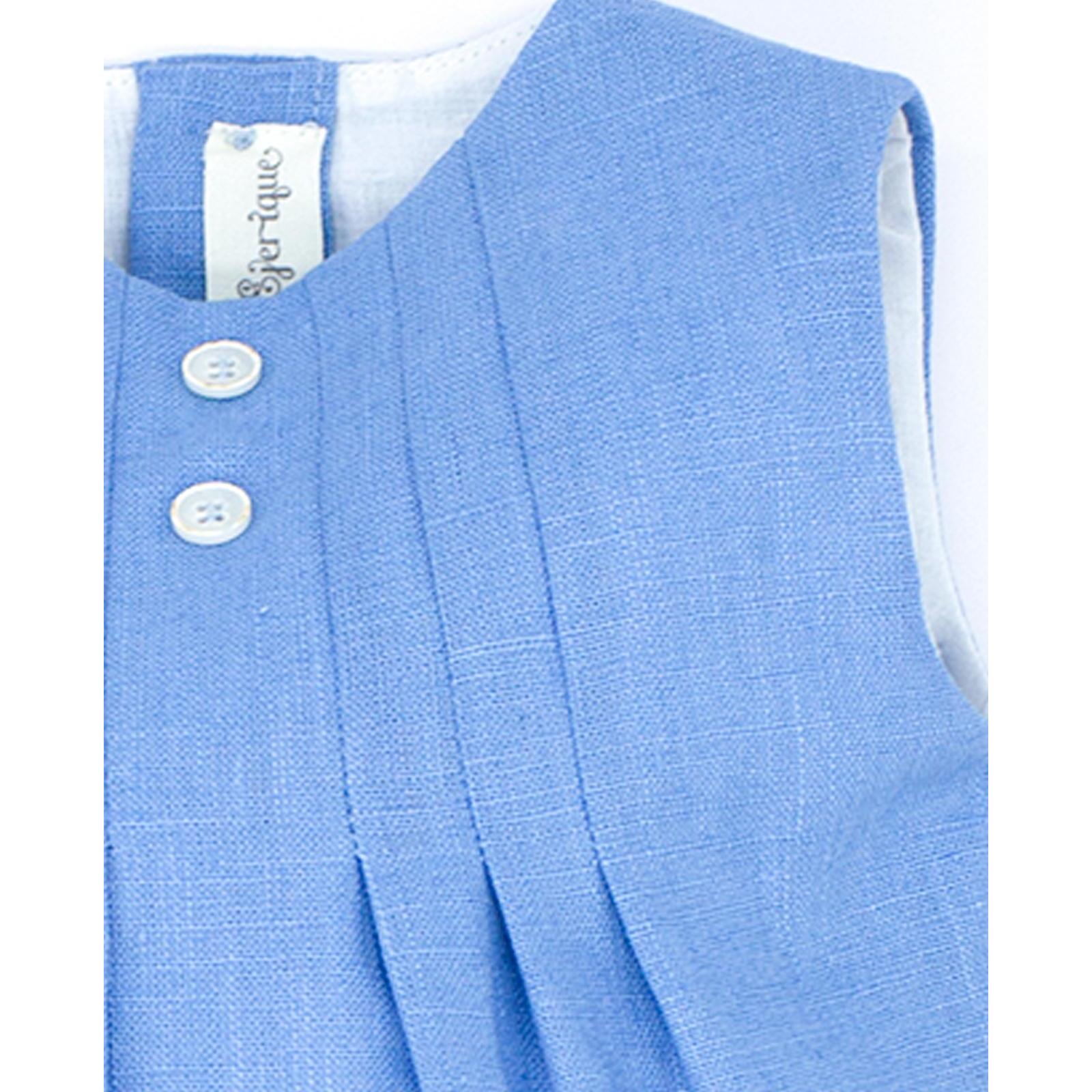 Pelele de lino azul. Con pliegues en el delantero y botones de decoracion.