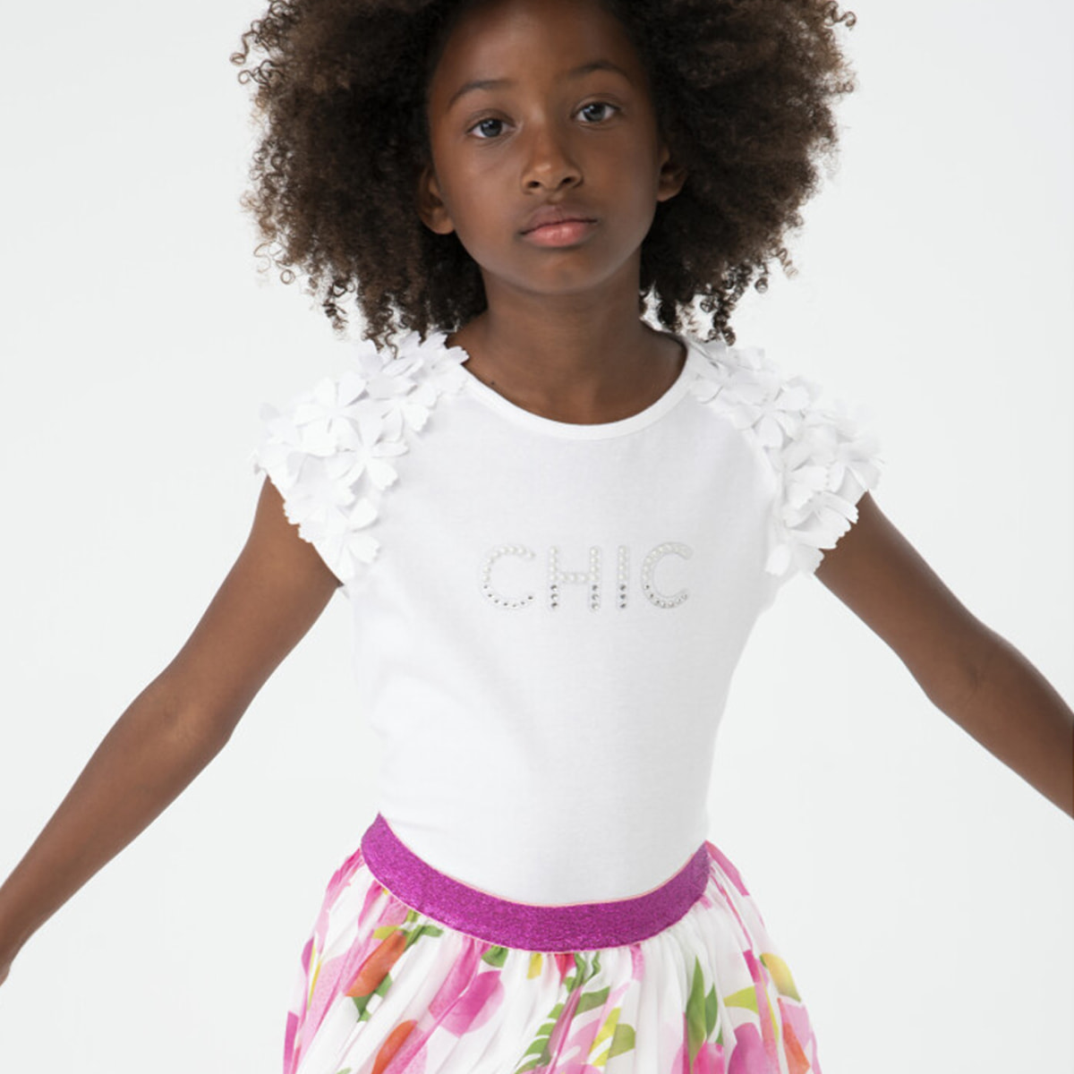 Falda plisada para niña estampada con flores de color rosa