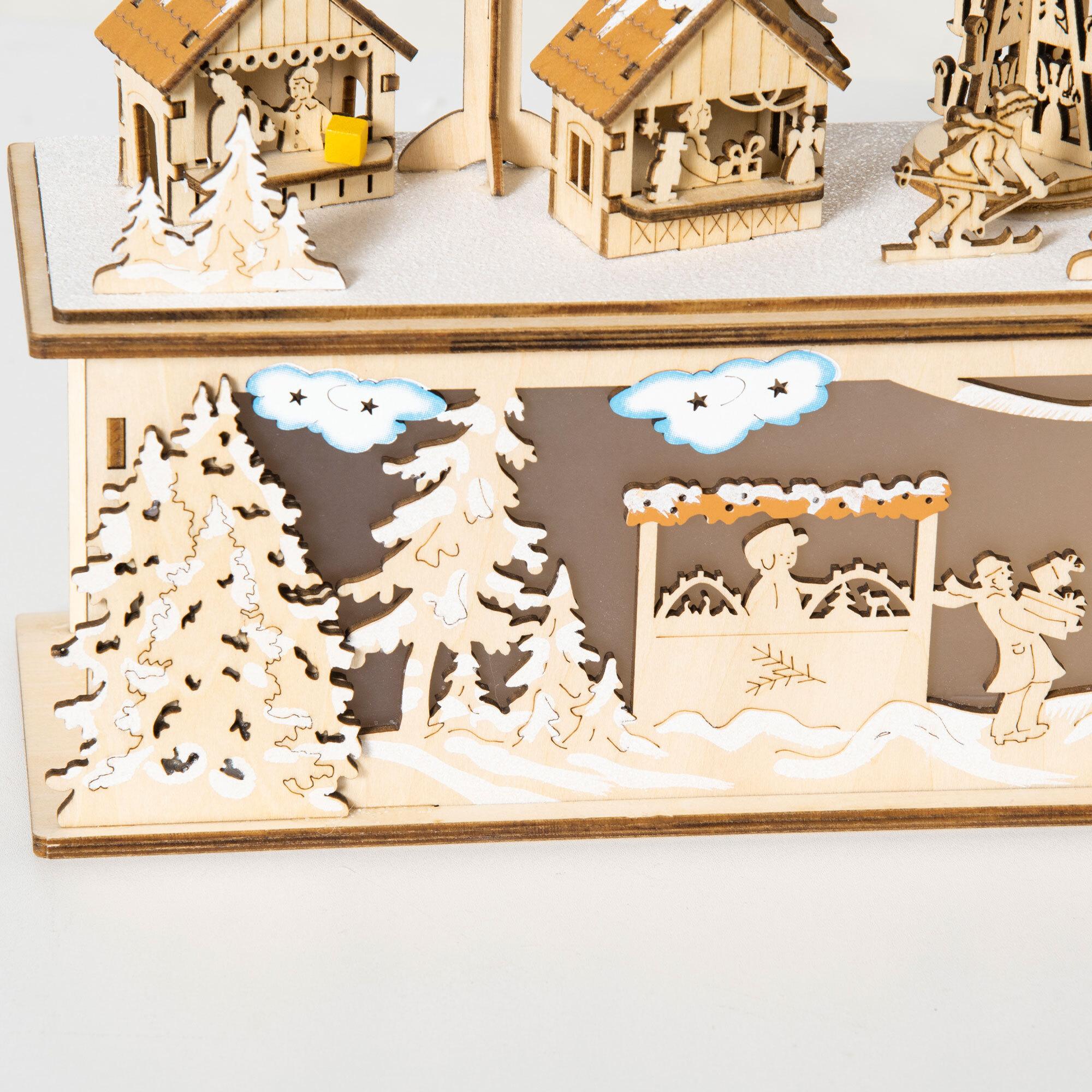 Village de Noël lumineux avec église, maisons, personnages