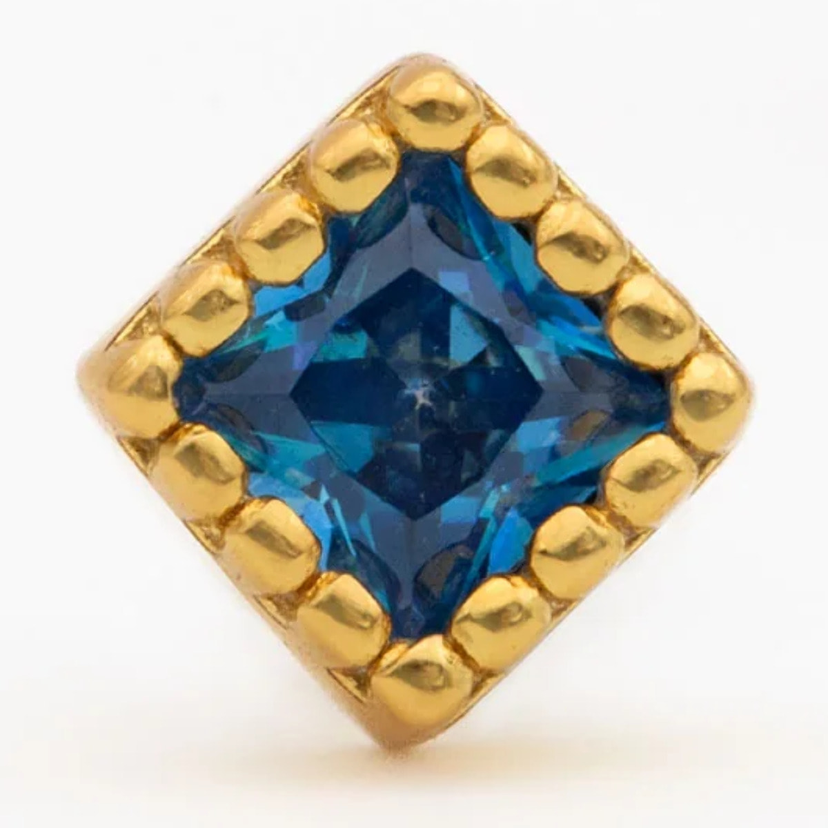 Piercing dorado con circonita azul