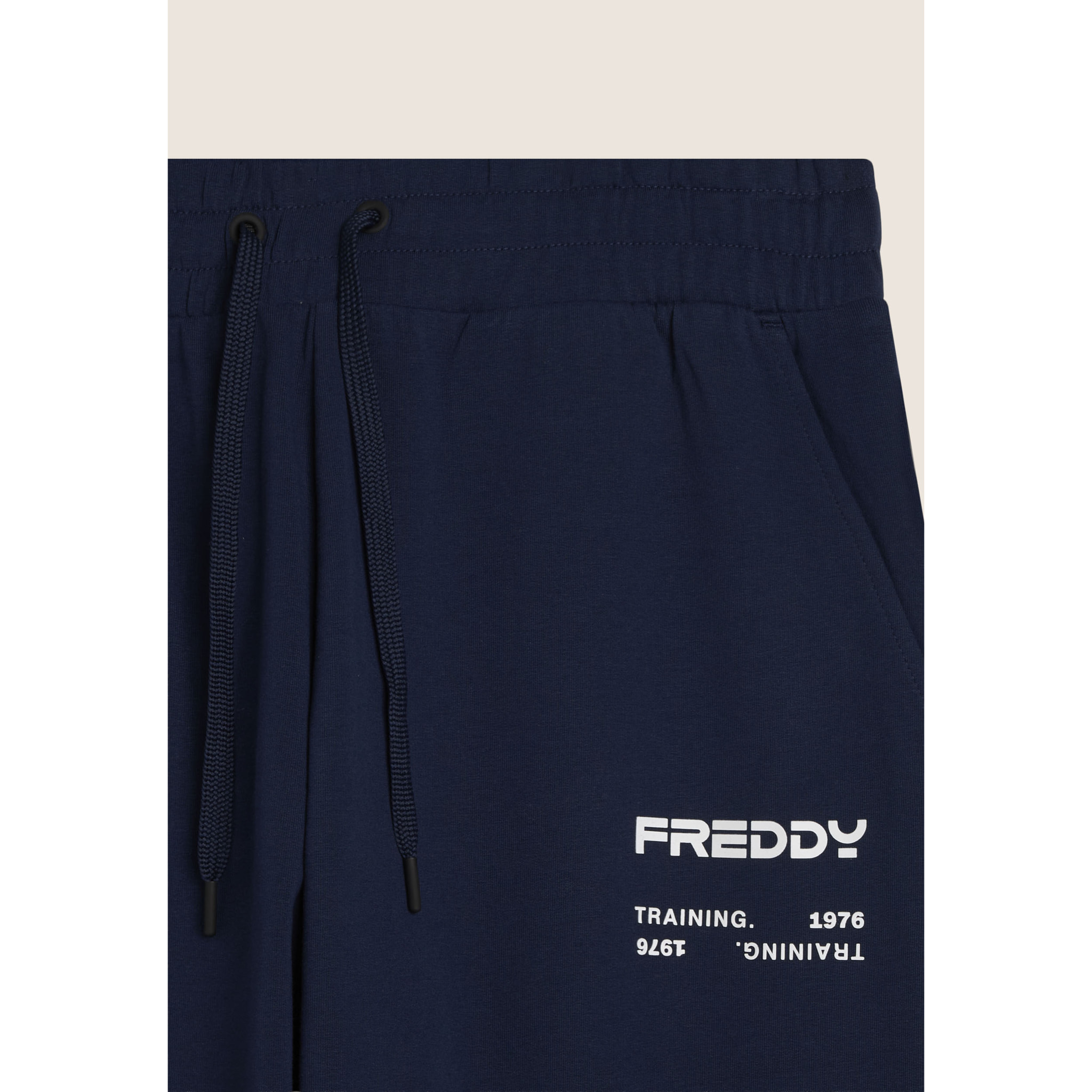 Pantaloni sportivi con bande laterali e fondo a polsino