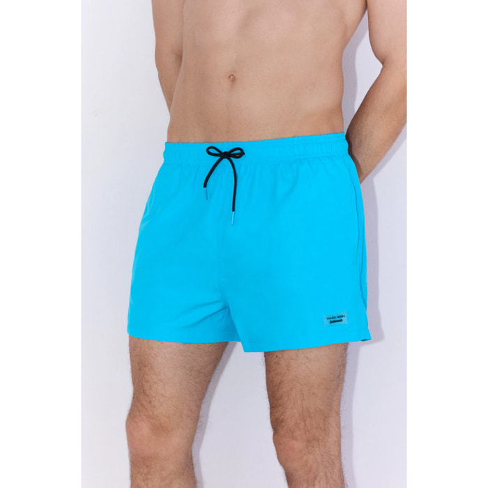Costume corto azzurro con dettaglio tasche