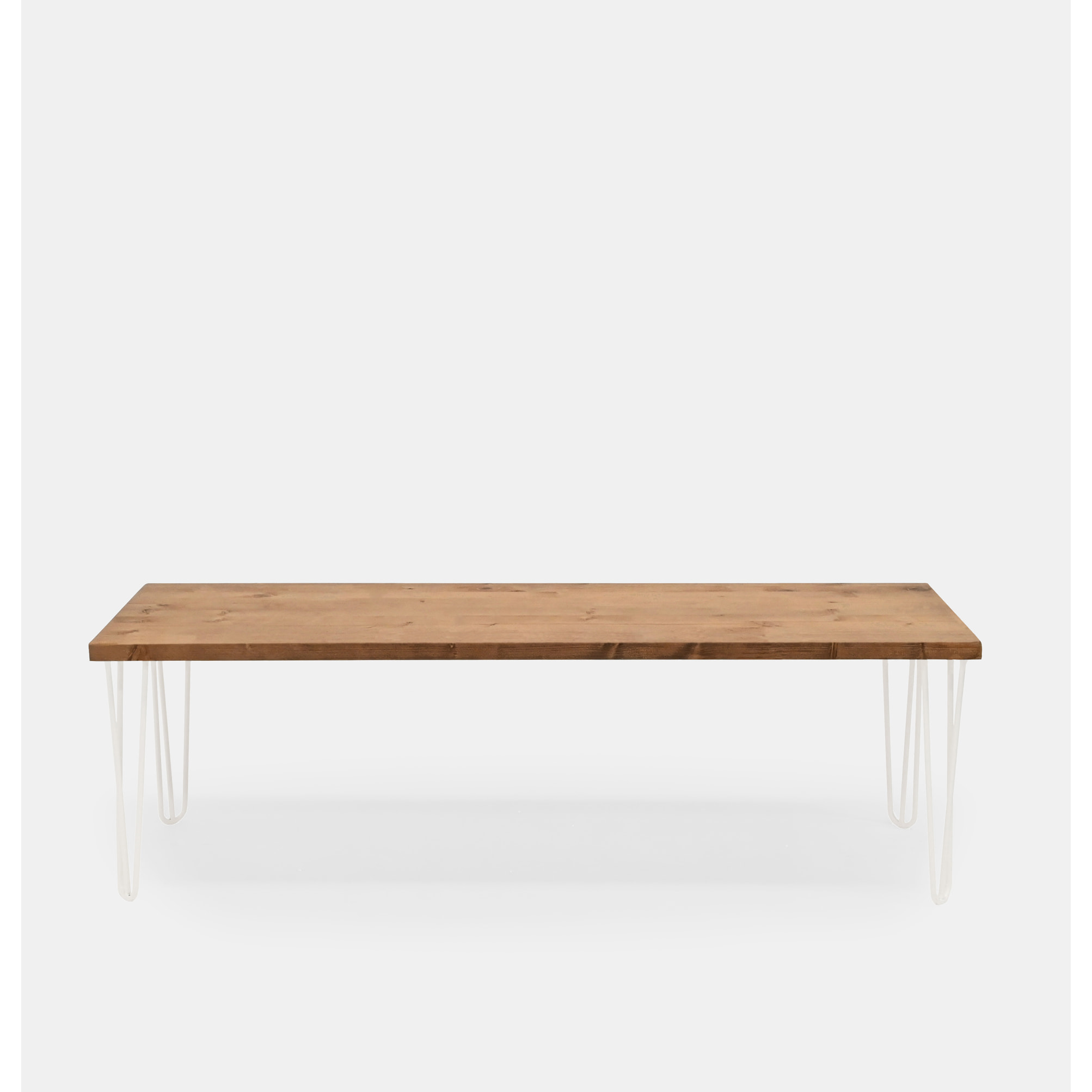 Banc en bois massif de couleur chêne foncé et pieds en fer blanc de différentes tailles.