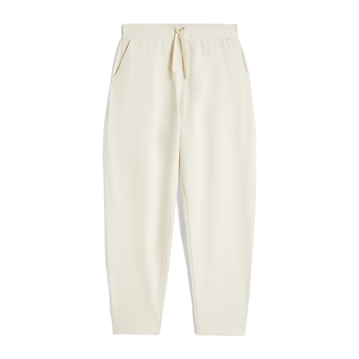 Pantaloni carrot fit in french terry con grafica sul fondo