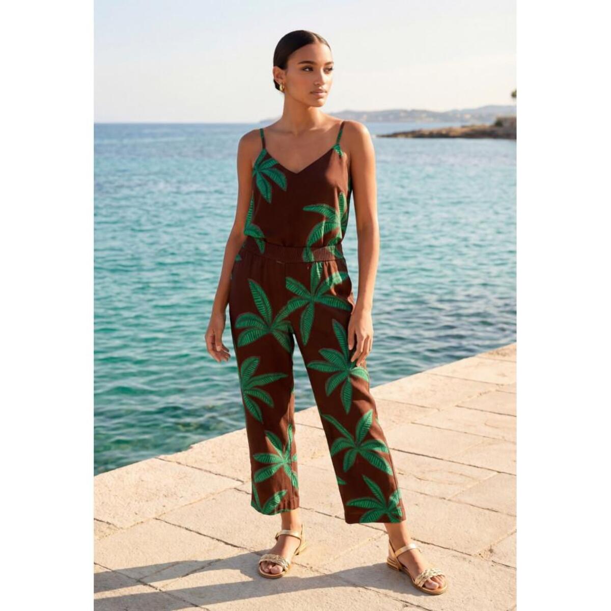 Pantaloni con sfondo marrone e palme