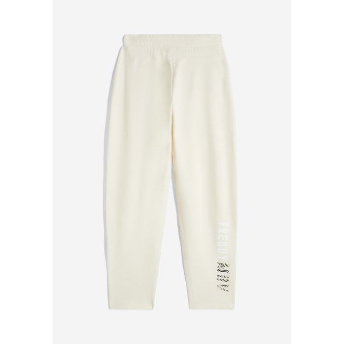 Pantaloni carrot fit in french terry con grafica sul fondo