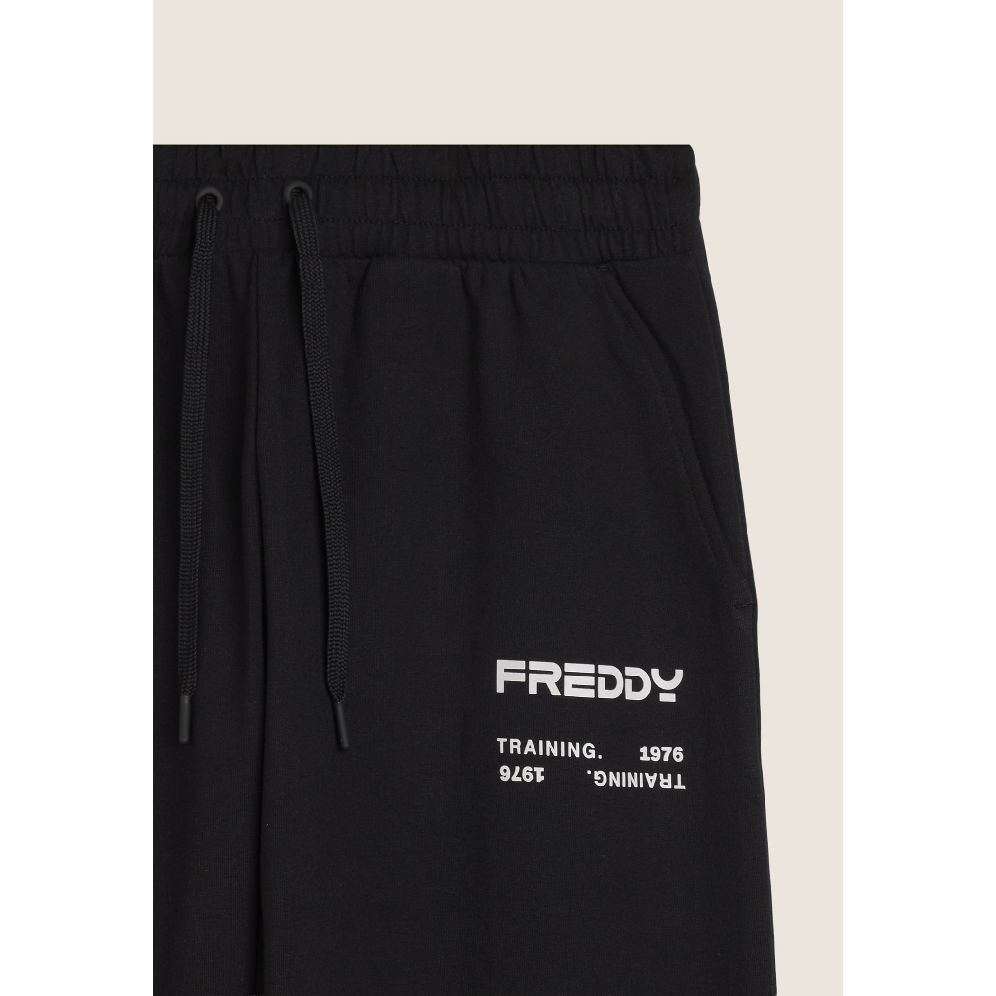 Pantaloni sportivi con bande laterali e fondo a polsino