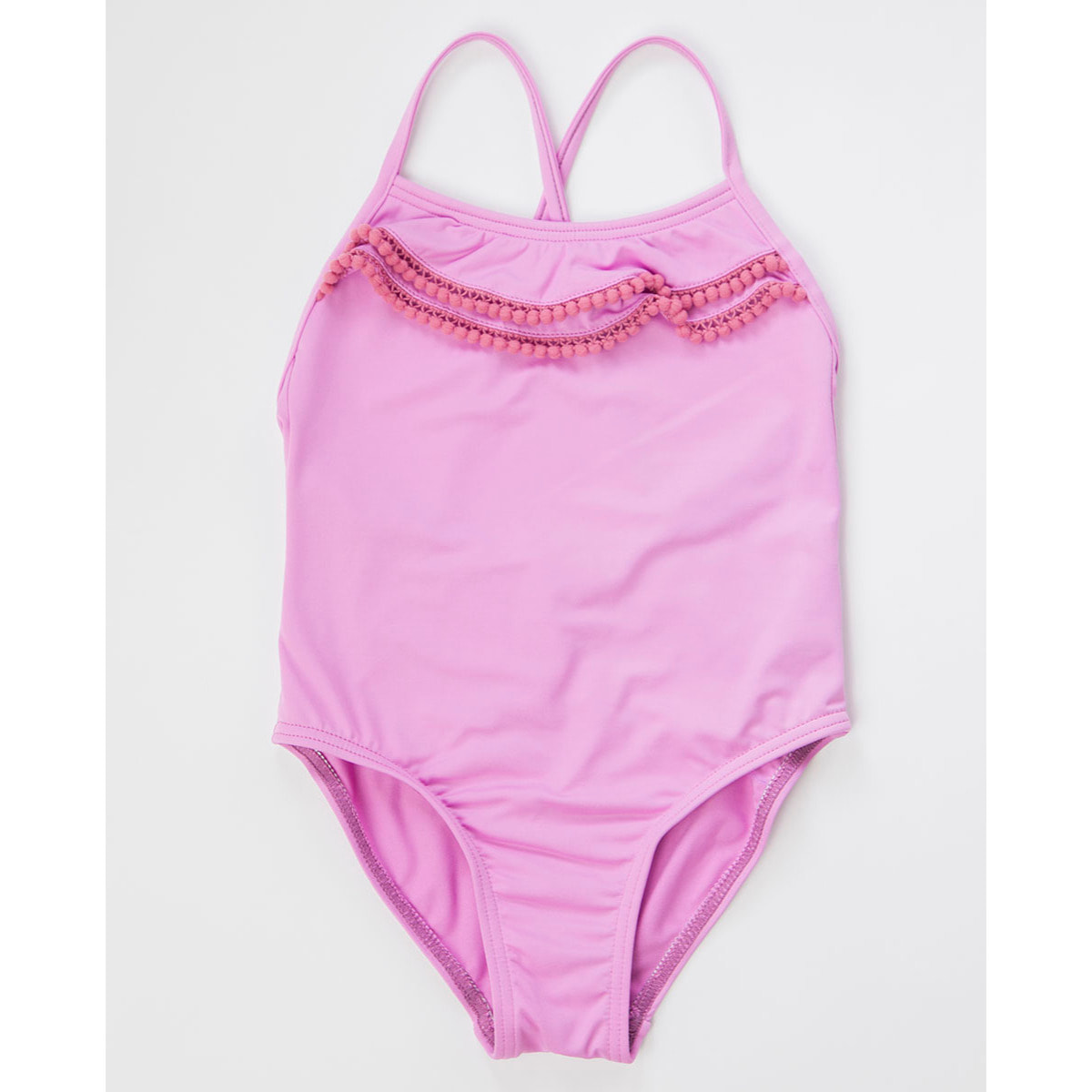 BAÑADOR ROSA CON TIRANTES CRUZADOS Y VOLANTES CON MADROÑOS EN ESCOTE