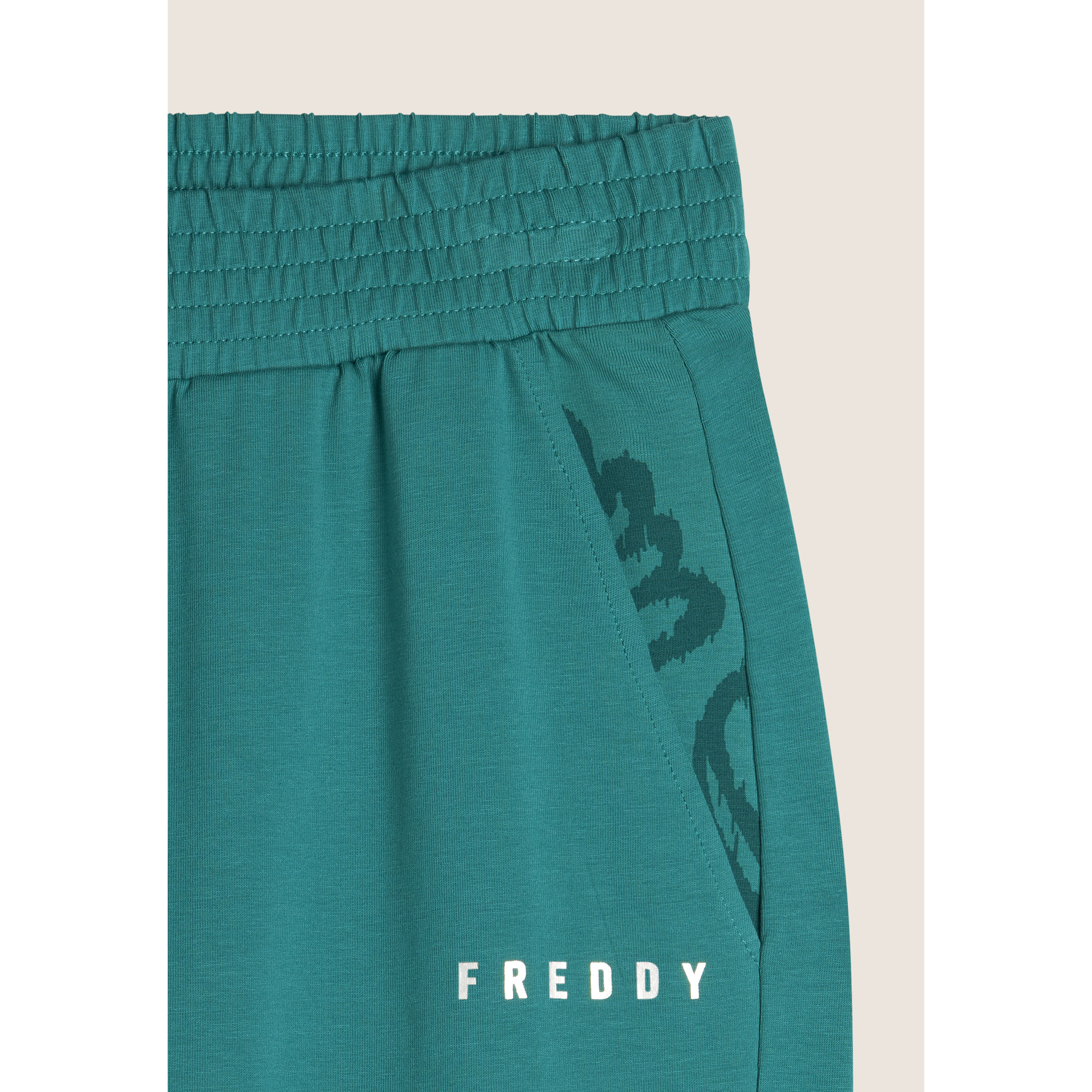 Pantaloni con elastico sul fondo e dettagli floreali