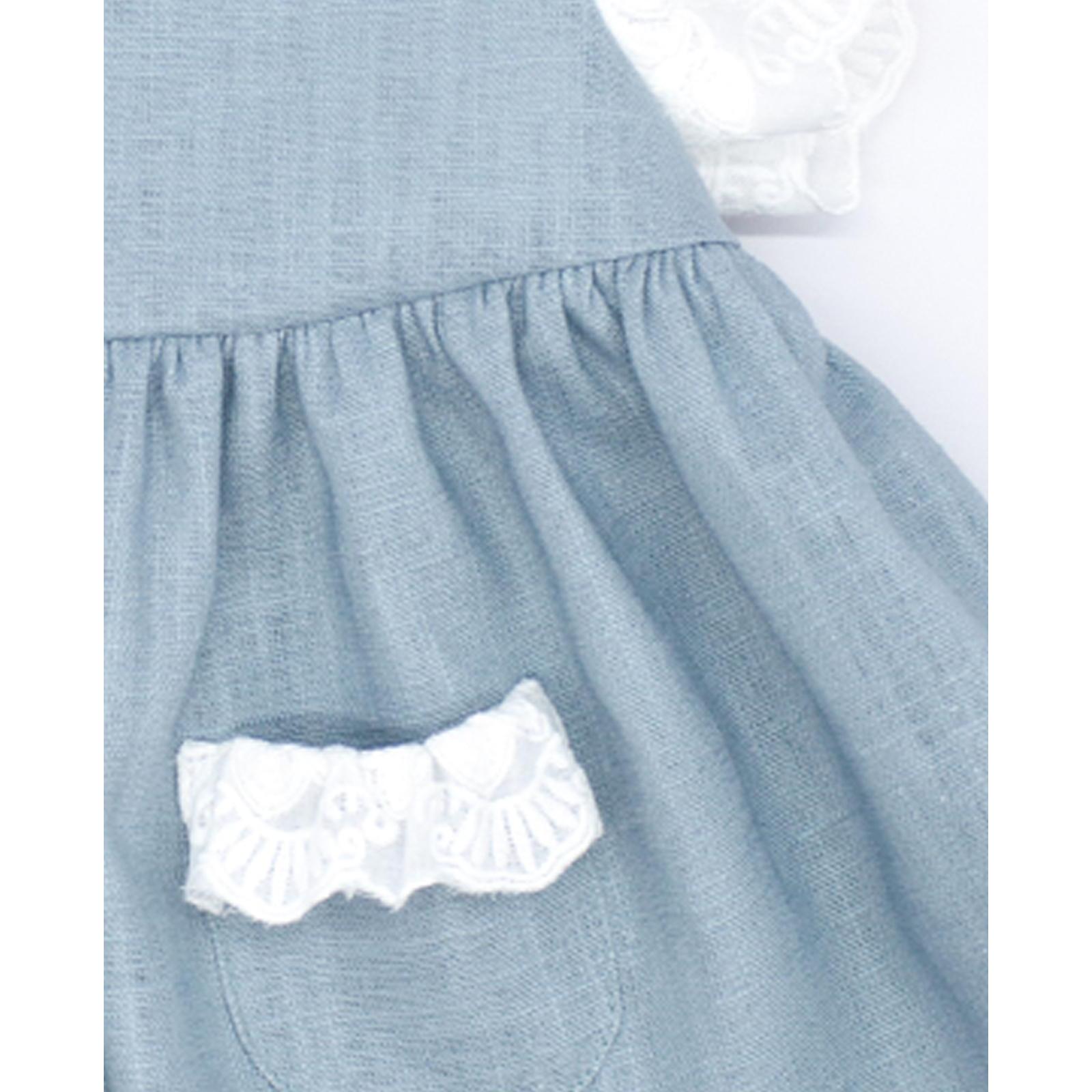 Vestido corto de lino verde, tira bordado en las sisas y los bolsillos.