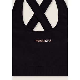 Top tecnico con spalline incrociate e profili bianchi