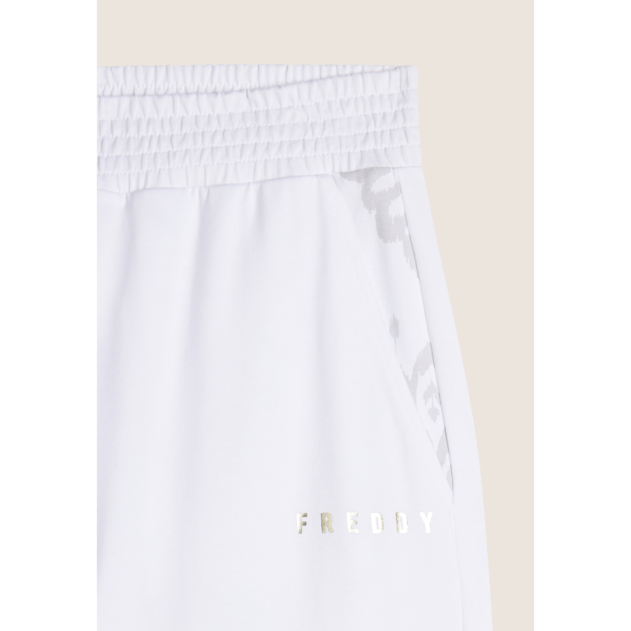 Pantaloni con elastico sul fondo e dettagli floreali