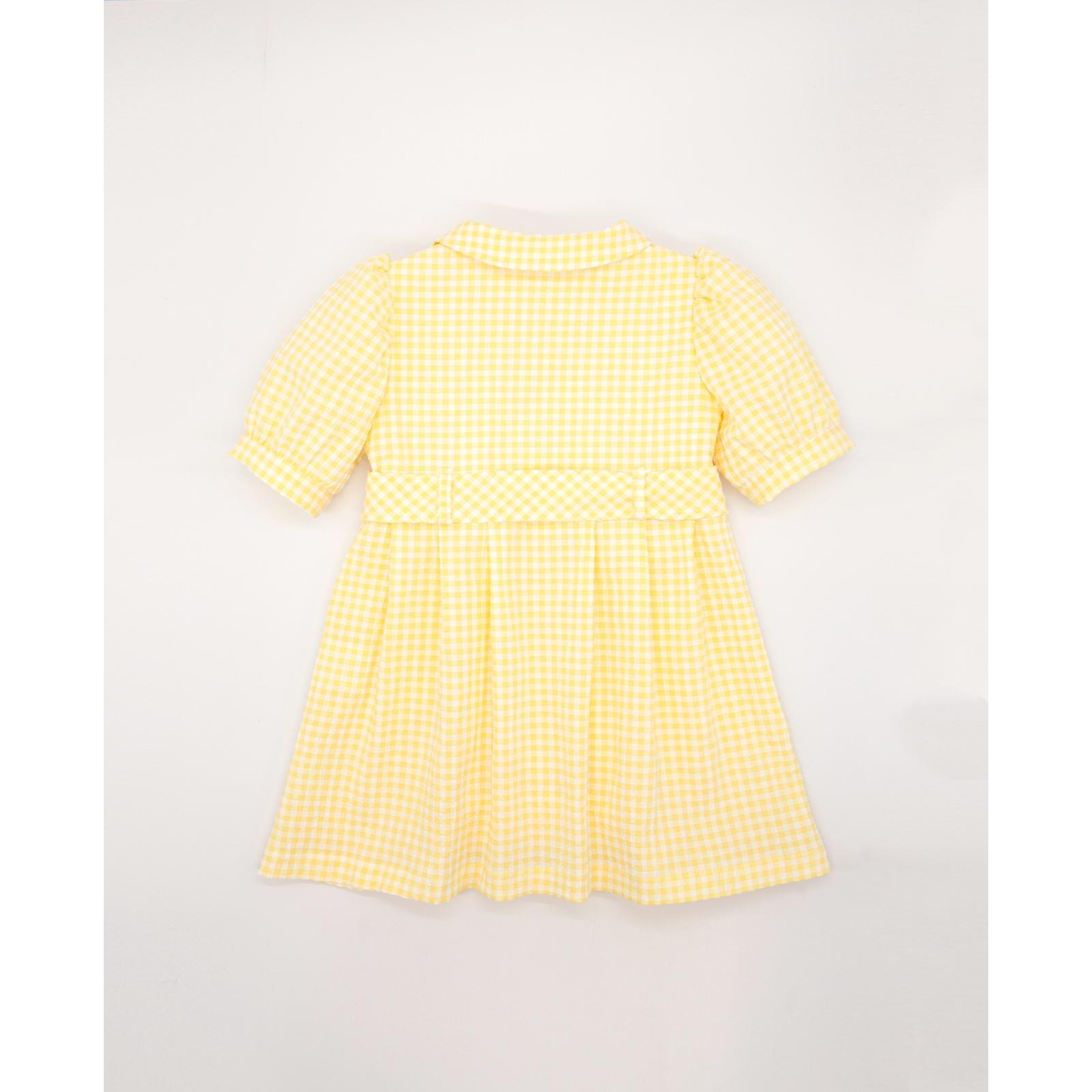 Vestido de manga corta de cuadros vichy amarillos. Bolsillos, cuello y cinturon. Botones en el centro.