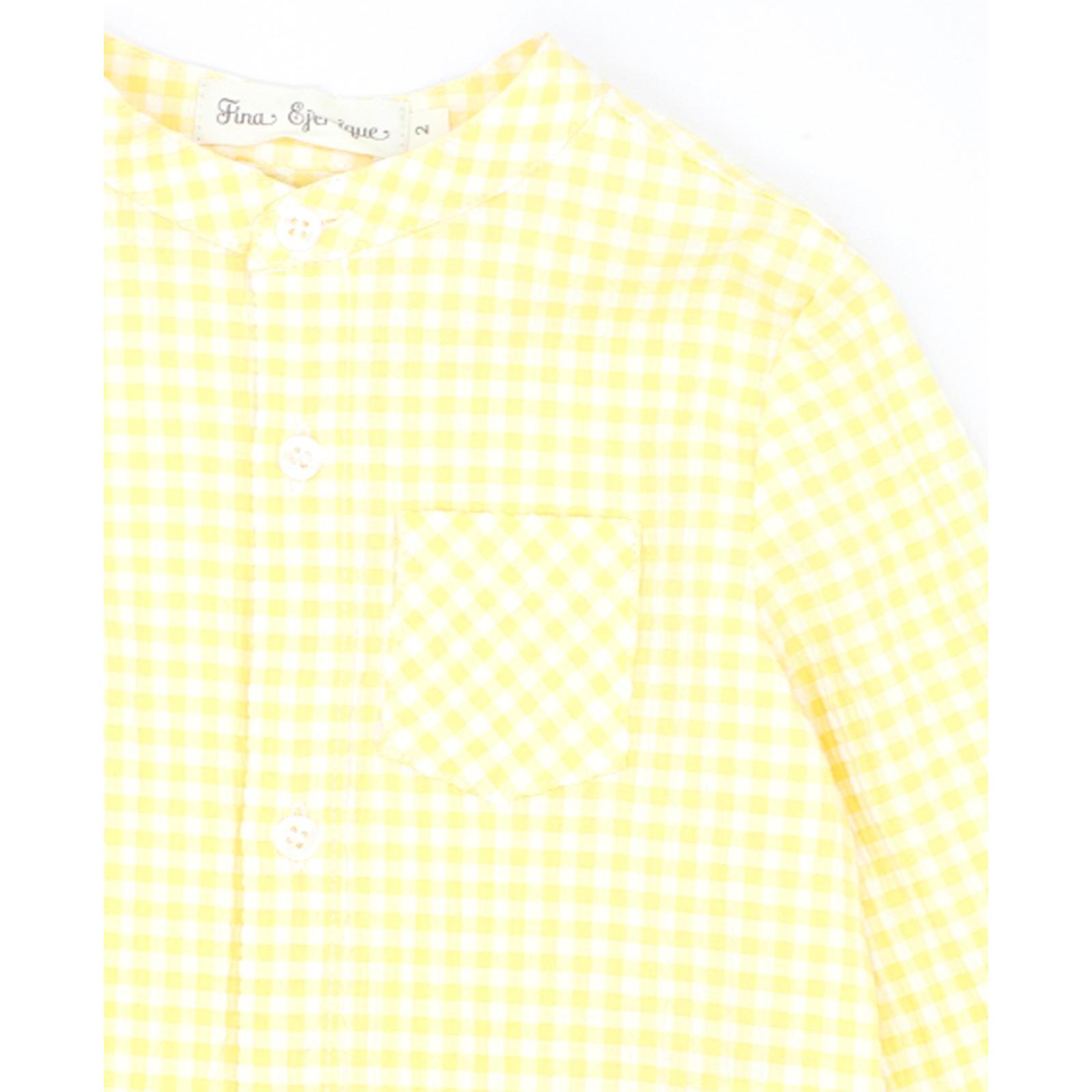 Camisa de manga larga estampado de vichy amarillo. Cuello mao y bolsillo en el delantero.